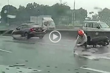 Video viral: derrapó con su moto bajo la lluvia y se salvó de ser atropellado por un camión